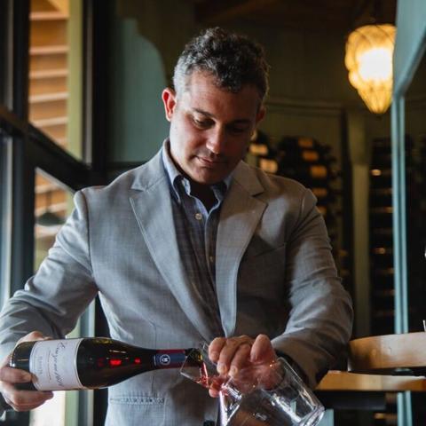 Stefano Poggi decanting a bottle of wine