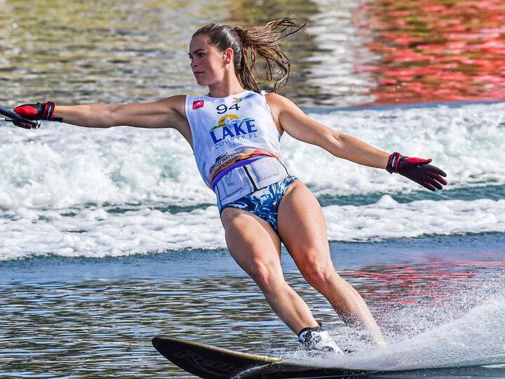 Neilly Ross mid-turn on a trick ski, spray rising behind her